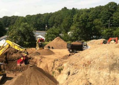 A group of people on top of dirt hill.